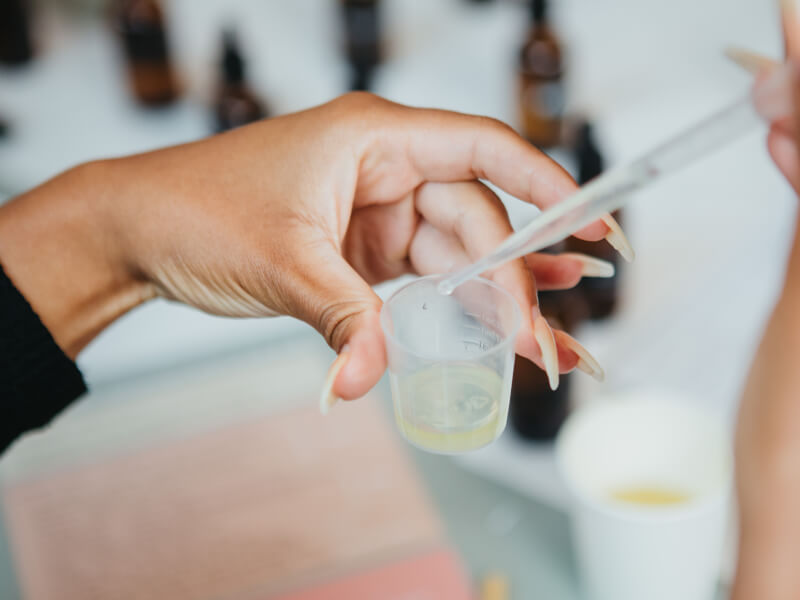 Hands holding measuring cup with liquid